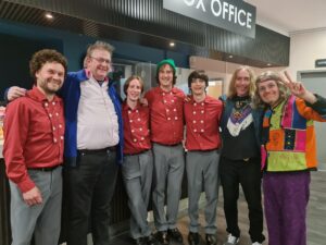 Monkees tribute band members at The Monkees Tale event, showcasing retro rock performance in vibrant outfits.